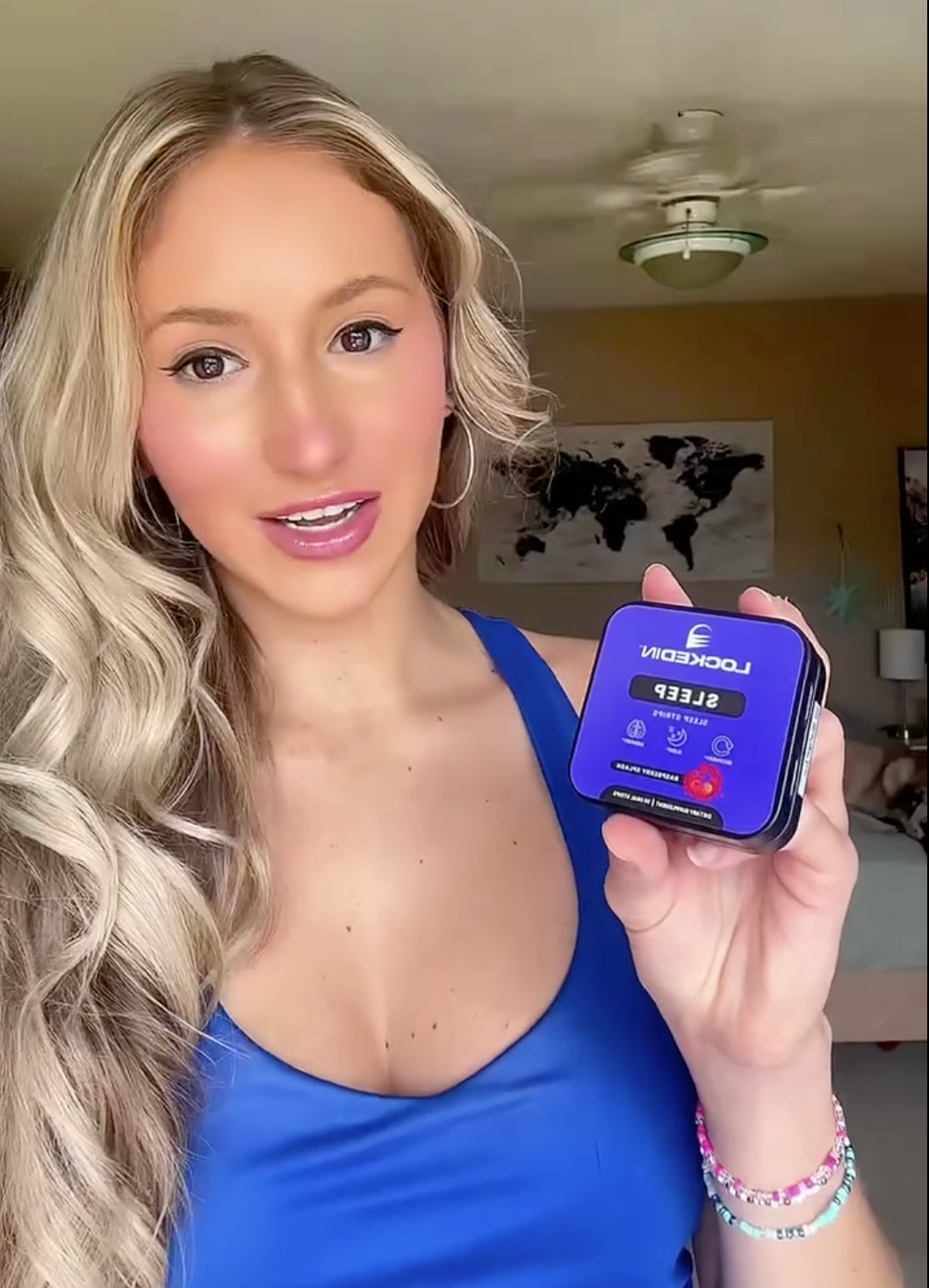 blonde female holding locked in sleep supplement giving a testimonial revies