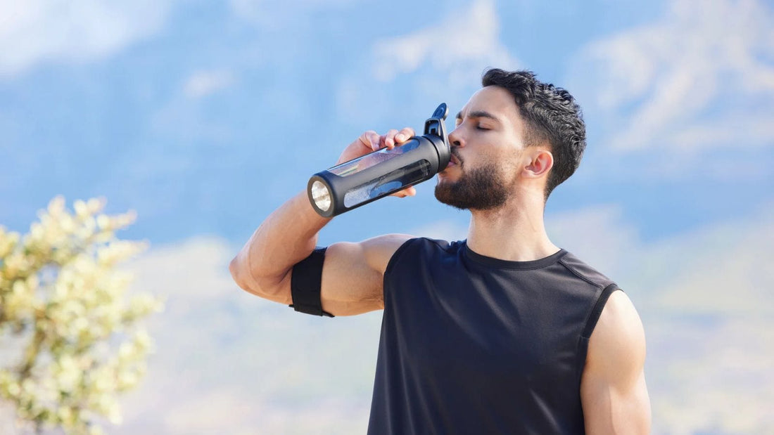 man in black athletic clothing drinking water