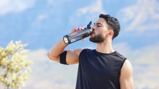 man in black athletic clothing drinking water