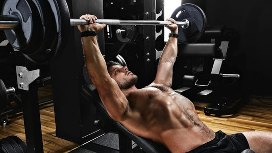 man training chest performing incline bench press