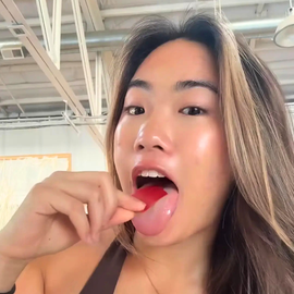 female using a locked in energy strip by placing it on her tongue