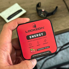 Hand holding a red 'Lockedin Energy' package with a blurred background