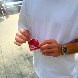 locked in energy strip being held in a mans hand outside 